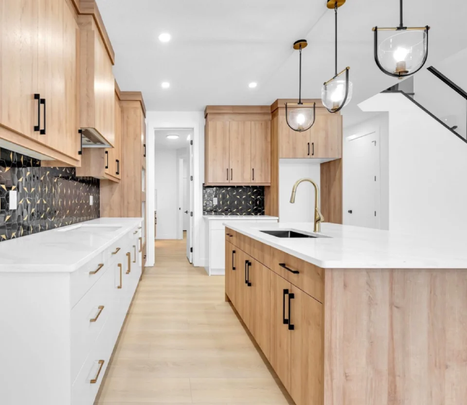 Galley kitchen with white oak cabinets, black hex tile backsplash and brass hardware